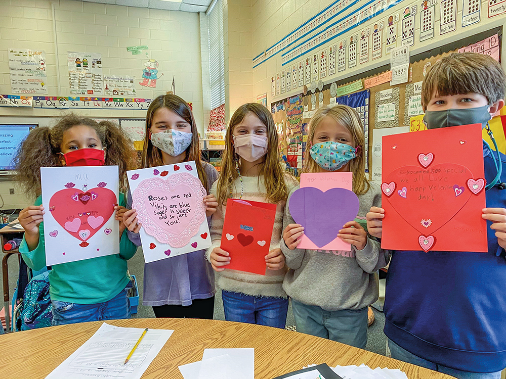 Children prepare cards for Valentine’s Day