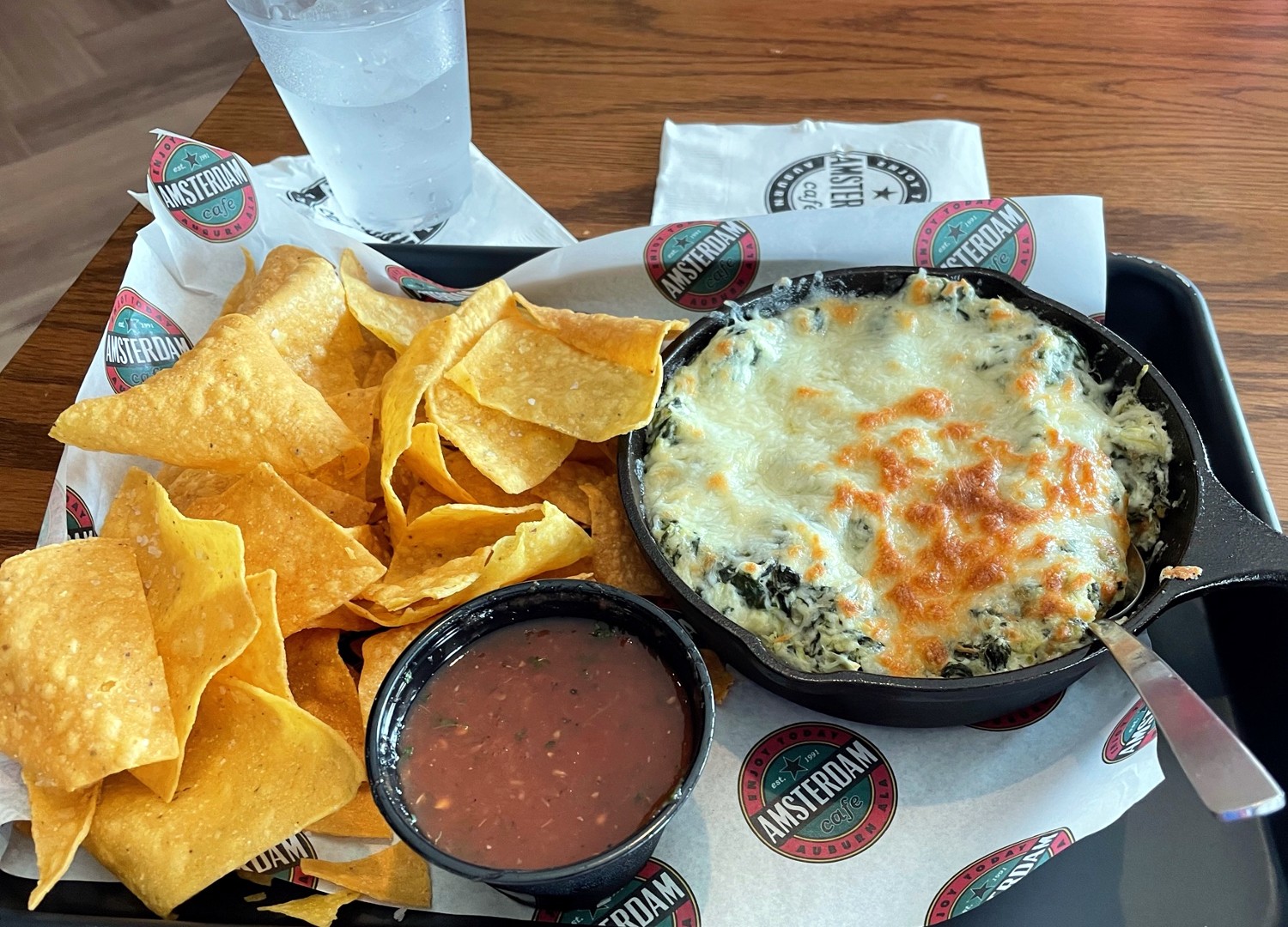 Spinach and artichoke dip with housemade salsa and corn tortilla chips is one of the appetizers offered at Amsterdam Cafe North.