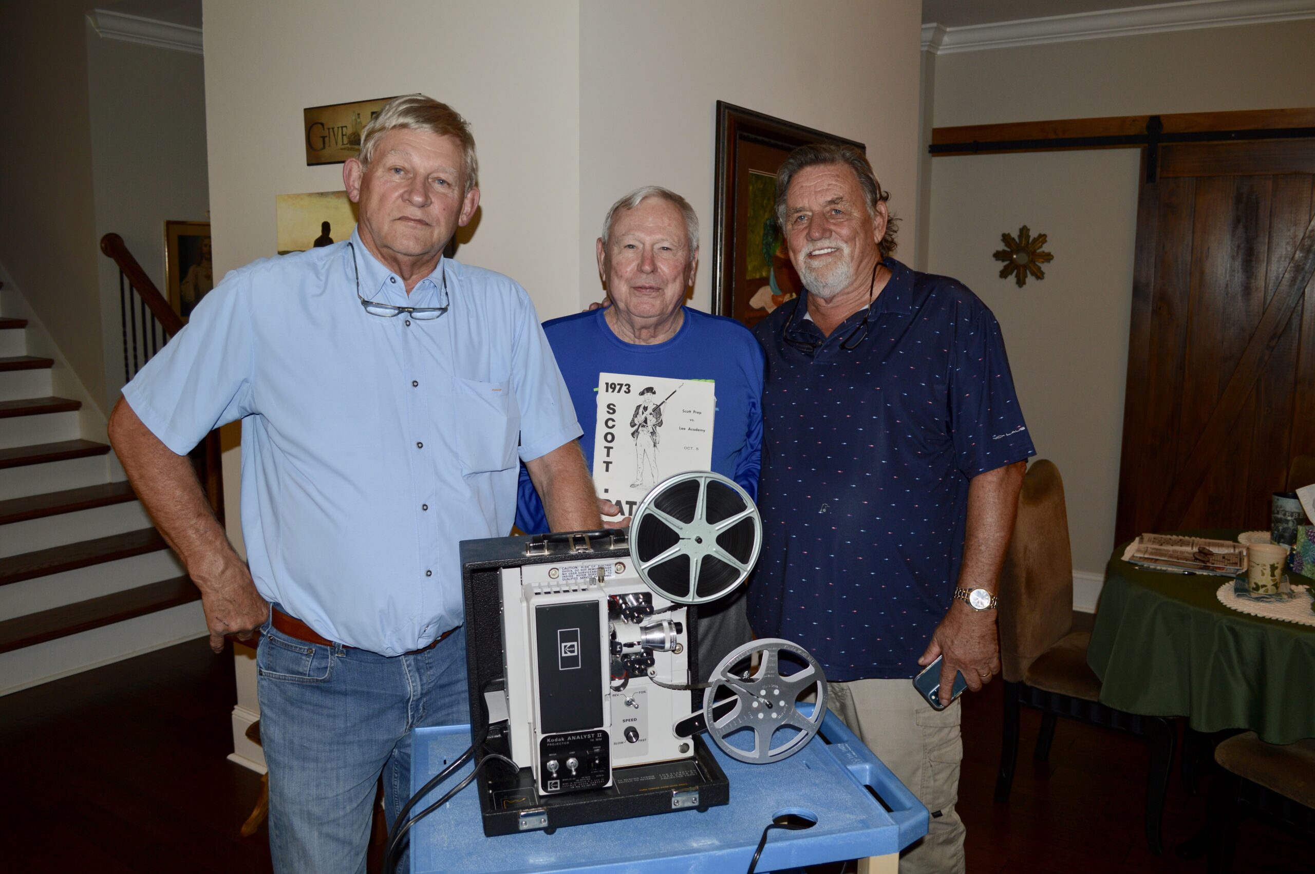Gathering for the 50th anniversary game film viewing at Coach Chuck Barber‘s house. Pictured from left to right are Boykin Smith (Scott Prep #26), Chuck Barber (coach at Lee Academy in 1973) and Ricky Dorris (Lee Academy #40)