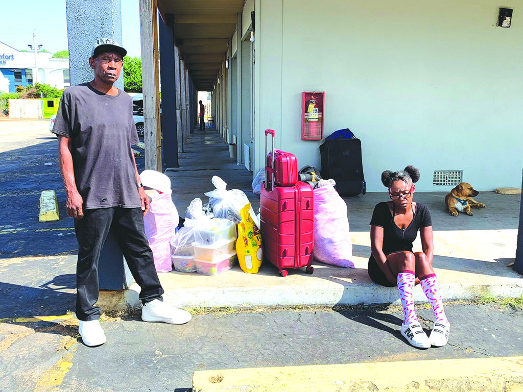 Residents of the Springwood Hotel in Opelika, Alabama, sit amongst their belongings as they try to find a new place to live.